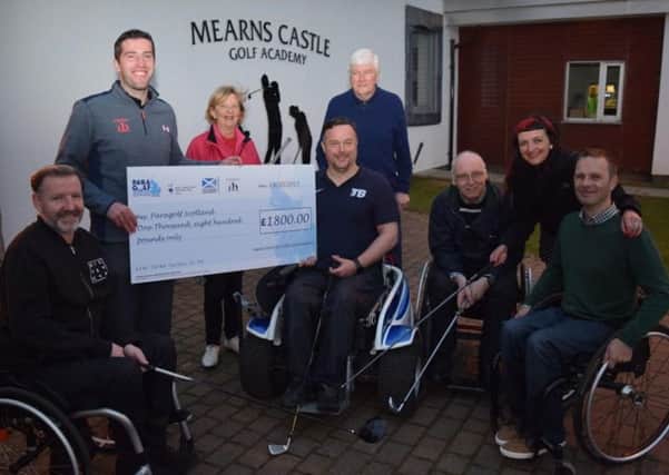 A cheque for £1800 presented to Ryan MacDonald by Russell Gray  MCGC