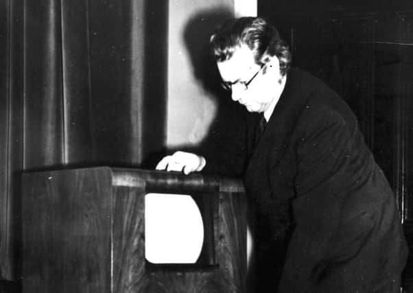 Scottish inventor of television John Logie Baird with an early TV set.