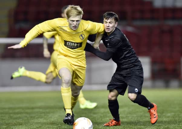 Stephen O'Neill (right) battles for possession during Colts' win over BSC Glasgow