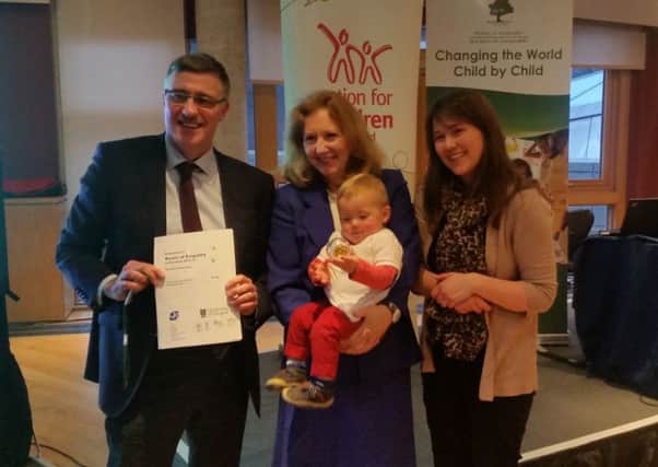 Action for Children's Roots of Empathy programme is having a significant impact on classroom bullying and aggression. From left, director of children's services Paul Carberry, Mary Gordon and Aileen Campbell MSP, whose son Crawford is being held.