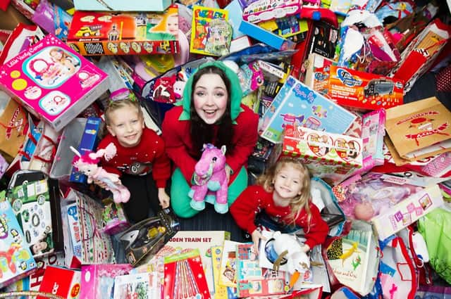 14/12/15 . GLASGOW: Academy Park. Children 1st. Orla(7) and Mara (4) Livingston from Erskine deliver sack fulls (more than 200 toys) of presents they have  raised for charity to Twinkle McSparkle the Elf. Children 1st charity 0141 419 1150 or  Sally Hall 07776347267.