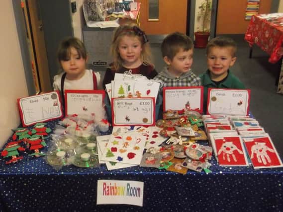 Some of the nursery children proudly displaying their wares
