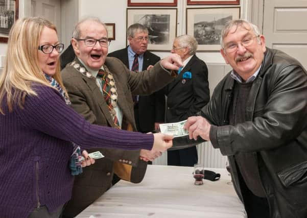 Handing over the £1 notes to claimant at the Het Pint (Pic Sarah Peters).