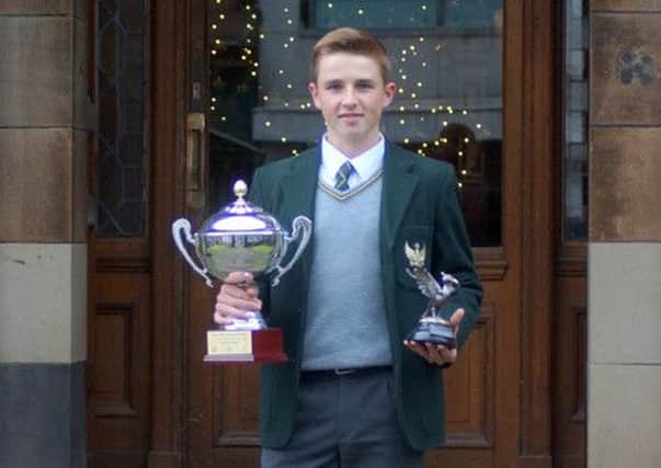 Aidan McHugh proudly shows off the trophies he won in Dubai and Liverpool.
