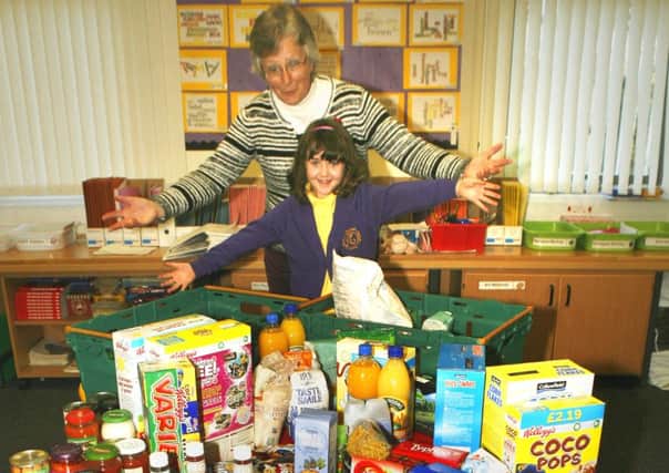 Schools have rallied round the Food Bank; Liz Barthram is seen with young Laura McIlvanney at Robert Owen Primary. (

Pic by James Clare)