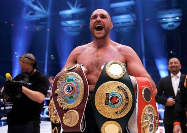 Tyson Fury with his world heavyweight belts (Submitted pic)