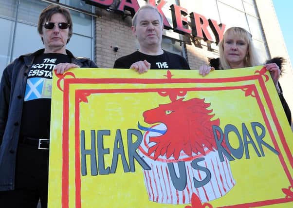 Scottish Resistance members (l-r) James Scott, Sean Clerkin and Gwen Sinclair protest outside Tunnocks in Uddingston.