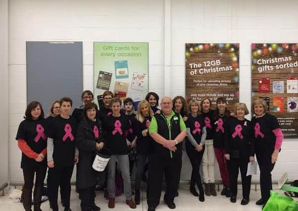 Members of White Lily Fund packed bags in Asda Bearsden