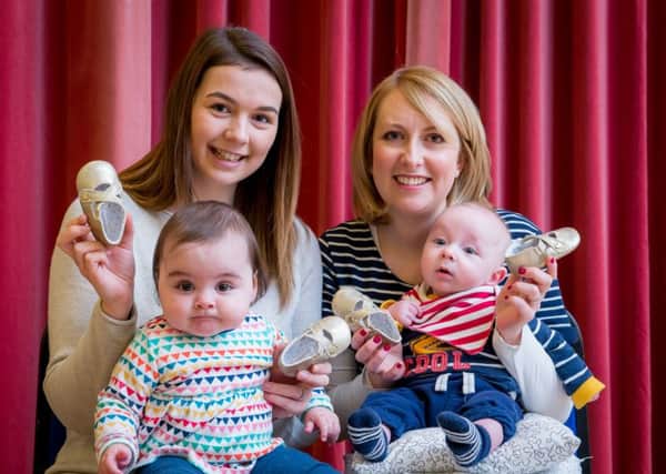 New mums were presented with tiny golden baby boots to highlight how they collectively kicked flu into touch by getting the flu vaccination when they were pregnant. From left, Sally Nisbet and daughter Lara and Hollie Lawson with son Theodore. (Picture by Fraser Band.)