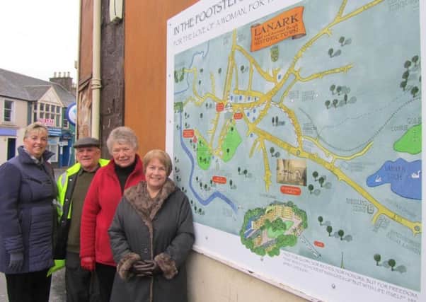 Lanark Development Trust members at the signboards following the Footsteps of William Wallace