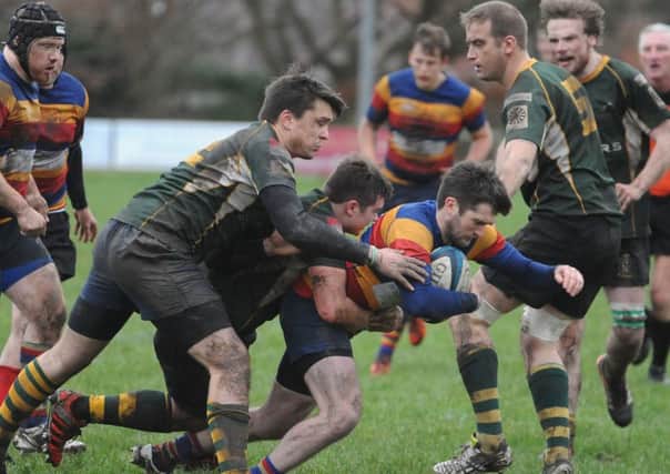 Lenzie's Tom McDermott on the attack against Helensburgh