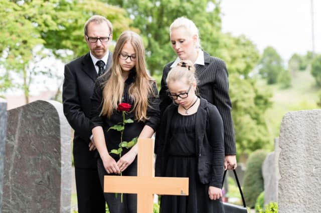 A family mourning together in a graveyard. See PA Feature FINANCE Death. Picture credit should read: PA Photo/thinkstockphotos. WARNING: This picture must only be used to accompany PA Feature FINANCE Death.