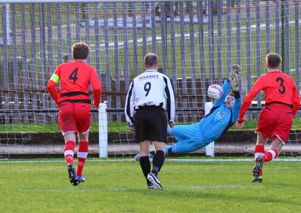 Jordan Brown's penalty save denies Beith. (Pic by Stephen Kerr)