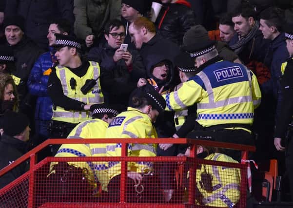 Police officers move in to make the arrest at Firhill last night.
