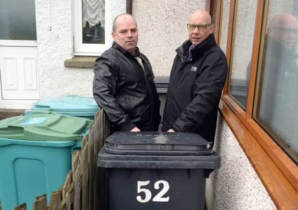 Stephen Guthrie (left) and Ian Lowe take the bin out at 52 Montalto Avenue, just as they have done for the last decade.