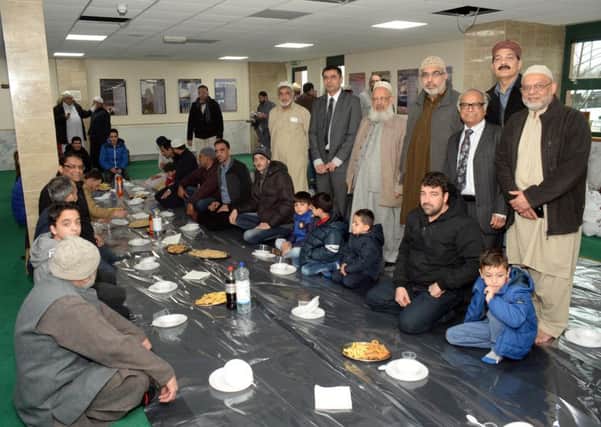 Syrian refugees sit down to lunch at the mosque