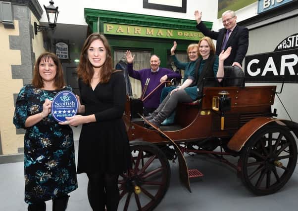 VisitScotland Regional Director Annique Armstrong presenting museum manager Jennifer Court with the award, cheered on by museum curator Suzanne Rigg and Trustees Michael Hunter, Ann Matheson and Eric Carlyle.