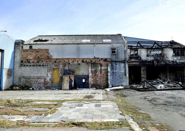 Alston's garage building and yard with fire damage in 2013 and lying derelict now.