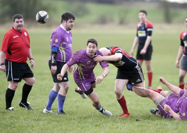 Cumbernauld scrum half and captain Jordan Reid makes a timely clearance from the base of a ruck
