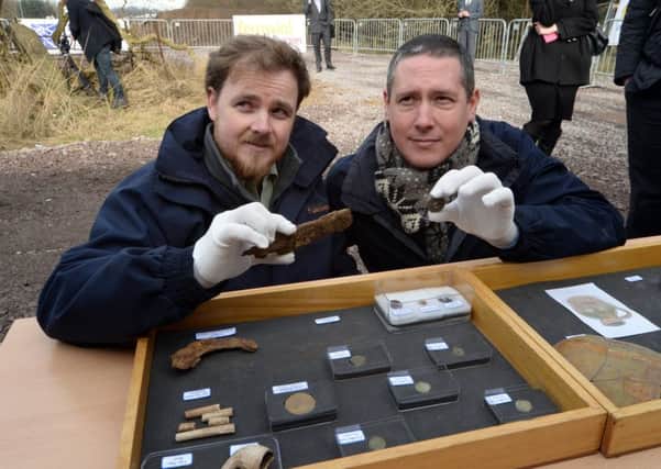 Archeologists Kevin Mooney and Warren Bailie with some of the artefacts.