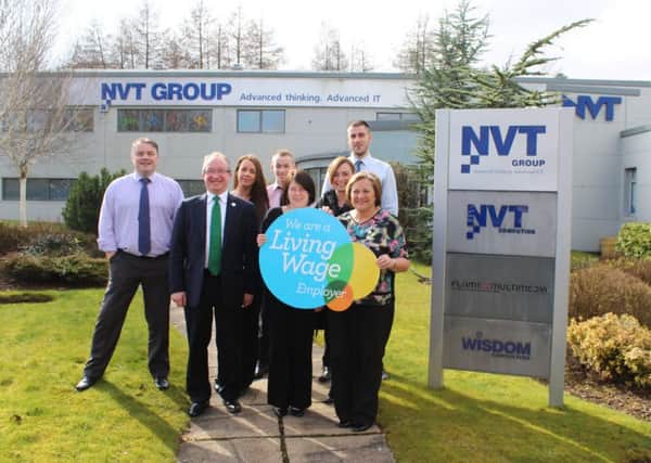 Staff from NVT Group show their commitment to the living wage with John Wilson MSP.