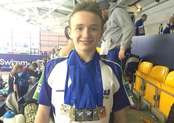 Douglas Kelly of Milngavie & Bearsden Swimming Club with his Scottish National Age Group medals