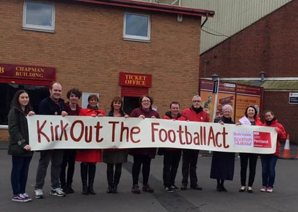 Labour activists make their message clear outside Fir Park on Saturday.