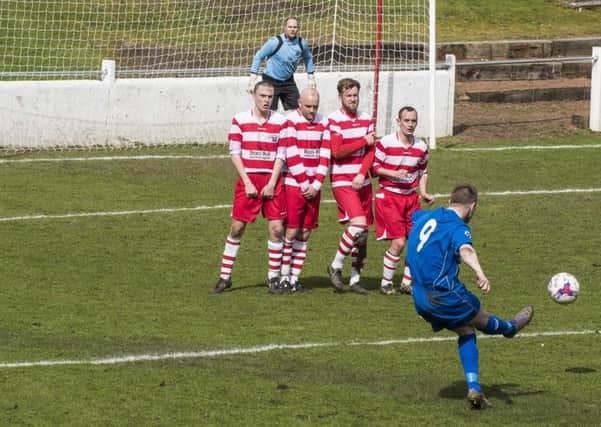 Carluke's Ian Watt strikes a free-kick towards goal during the win against Lesmahagow on Saturday (Pic by Sarah Peters)