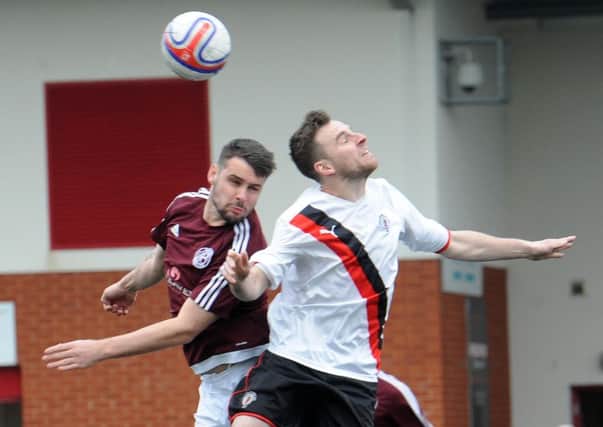 Rob Roy's Chris Duff battles with a Petershill opponent.
