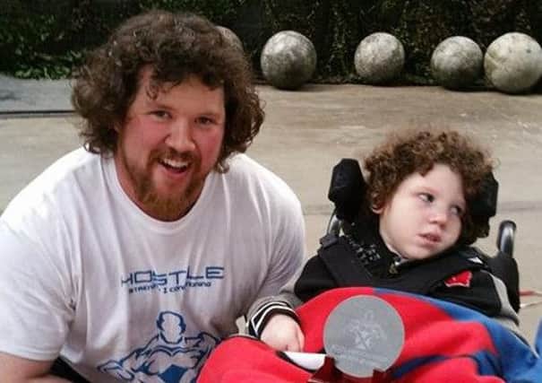 Strongman Dhanni Moar with seven-year-old Mason Eadie.