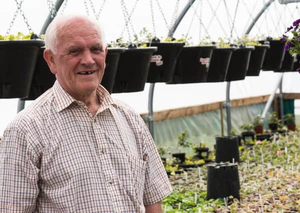 Lanark in Bloom chairman Ernest Romer with baskets and plants being prepared for the season. (Picture Sarah Peters)