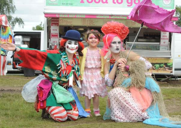 At last year's Mugstock Music Festival. Clara Knight (4) from Bearsden with entertainers.