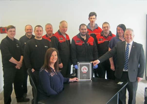 George Chestnut, Vauxhall After Sales District Manager presents Jennifer Bulloch and her team with their Customer Excellence Award.