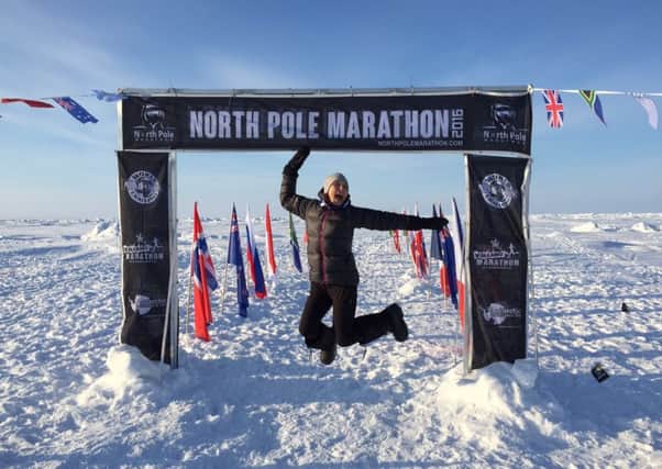 Kate celebrates completing the North Pole Marathon.