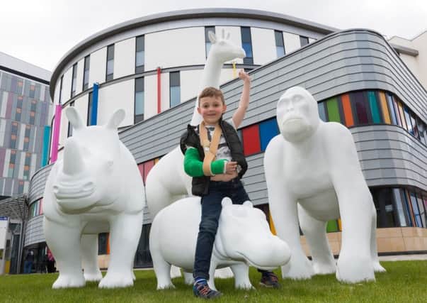 Sacha Aleksandr Marek (6) with "The Big Stampede" fibreglass animal statues at The Royal Hospital for Children Glasgow.  
COPYRIGHT Â© STUART WALLACE 2016
.