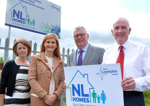 Pamela Humphries (development manager), Elaine McHugh (head of housing solutions), council leader Jim Logue and housing convener Barry McCulloch promote the NL Homes signage