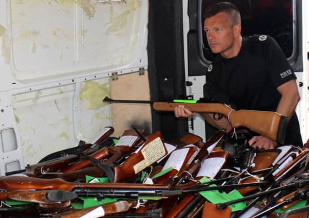 Assistant Chief Constable Mark Williams with some of the weapons already surrendered to police stations in Scotland