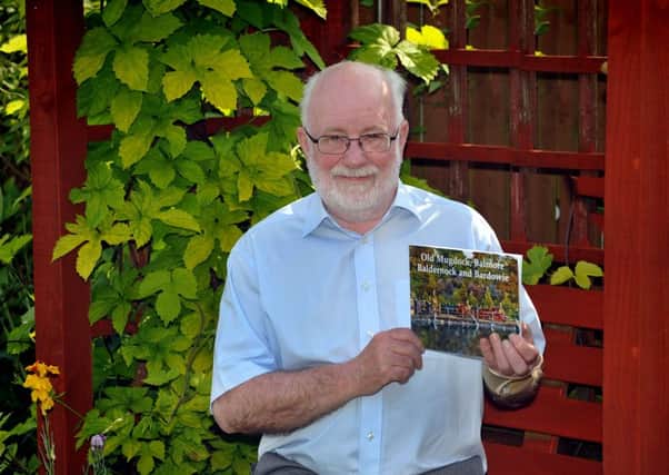 Jimmy Crawford with his new book of old postcards.