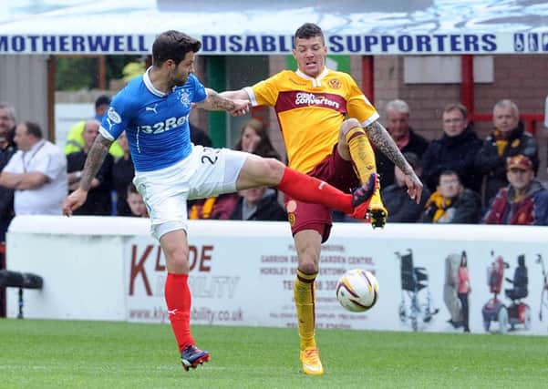 Motherwell's Marvin Johnson battles it out with then Ranger Richard Foster during the last Motherwell-Rangers clash at Fir Park in May 2015, which Motherwell won 3-0 to seal a 6-1 aggregate triumph in the sides' Premiership play-off (Pic by Alan Watson)