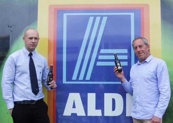 Aldi Motherwell deputy store manager John Armstrong with Plan Bee founder and CEO Warren Bader as they toast the deal with some Beehive Brae.