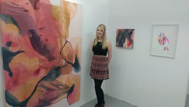 Jade Sturrock next to some of her degree show work.