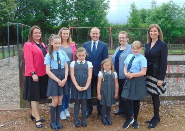 Welcoming phase two of the Hope Street Park upgrade are (l-r) Mossend Primary depute head Patricia McKay and parent council chairwoman Lorraine Elliot, Mossend and Holytown councillor Frank McNally, Holy Family Primary parent council member Elaine Haldane and head teacher Frances Wilson with members of the pupil councils from both schools.