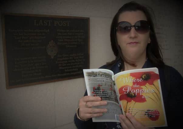 Irene Penman with a copy of her book "Where the Poppies are"