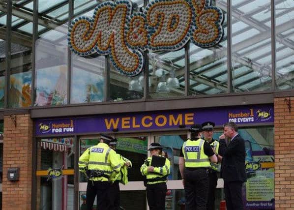 Police outside M&D's following yesterday's crash