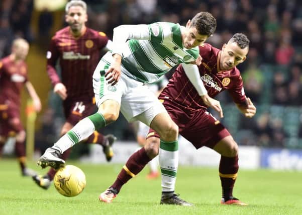 Lionel Ainsworth (right), battling for possession against Celtic at Parkhead last season, has been linked with a move away from Motherwell this summer (Pic by Alan Murray)
