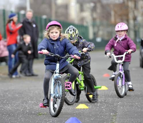 PIC PHIL WILKINSON.TSPL / JOHNSTON PRESS

Craigentinny Primary School -  An event was held today with youngsters at the school , with Sustrans , giving kids the chance to go around an obsticle course on bikes to gain confidence.
MSP Kenny Macaskill  , also attended and had a go for himself.

Pic shows the young cyclists going around the course.