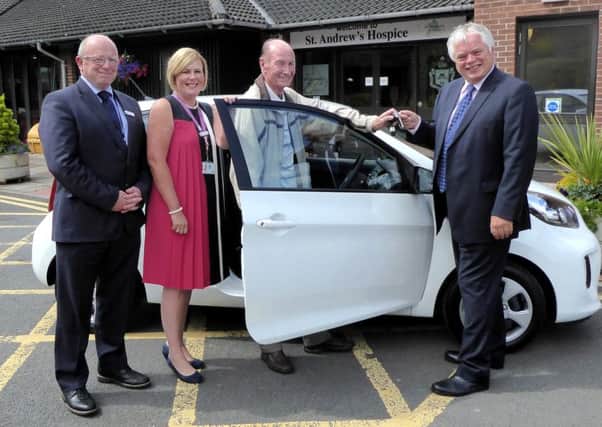 Motherwell man James Kearney receives his new car from Bruce High and Lorna McCafferty of St Andrew's Hospice  and Andy Thorogood of Bonnar Accident Law.
