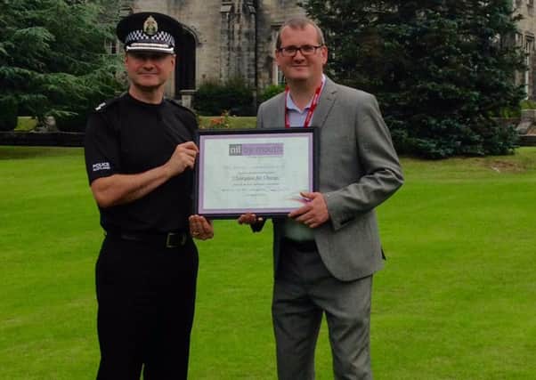 Nil By Mouth campaign director Dave Scott presenting the award to Lanarkshire Division Chief Superintendent Roddy Irvine at the National Police Training College.
