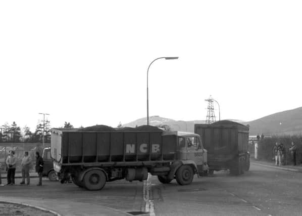 Two National Coal Board lorries make their way through an early morning NUM picket line outside Bilston Glen colliery during the miners strike in January 1985.