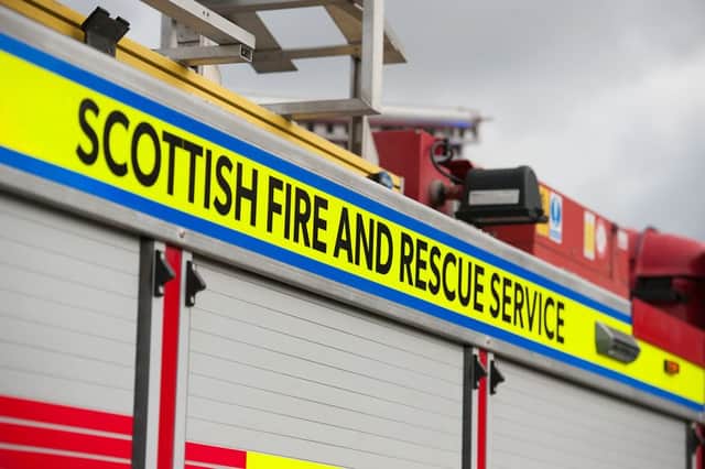 Firefighters rescued a man and woman from their car after it crashed near Milngavie on Sunday.